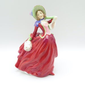 ceramic figurine of a women in a red dress